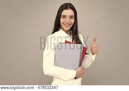 Portrait Of Student Woman. College Or High School Ducation. Young Woman With Notebooks Smiling At Ca