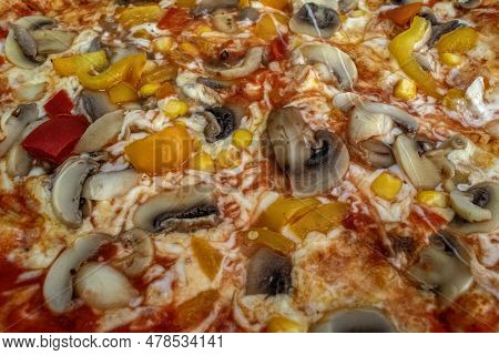 Funghi Pizza With Tomato Sauce, Cheese, Mushrooms, Peppers And Corn On Wooden Table