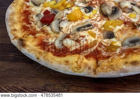 Funghi Pizza With Tomato Sauce, Cheese, Mushrooms, Peppers And Corn On Wooden Table