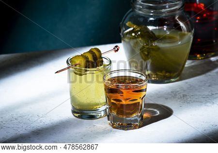 Pickleback, Alcoholic Cocktail Drink From Cucumber Pickle And Whiskey In Small Shot Glasses. Hard Li