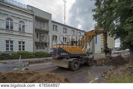 Poland Ostrowiec Swietokrzyski June 14, 2023 At 11:16 Am. Hyundai Excavator On The Street. Work On T