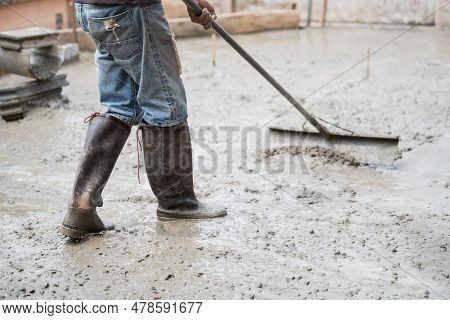 Skilled Builder Expertly Pours Cement On The Floor, Sculpting A Solid Foundation For The House With 