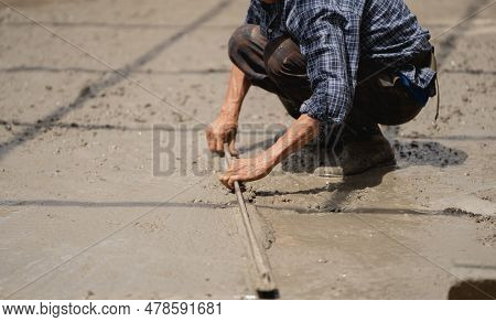 Skilled Builder Expertly Pours Cement On The Floor, Sculpting A Solid Foundation For The House With 