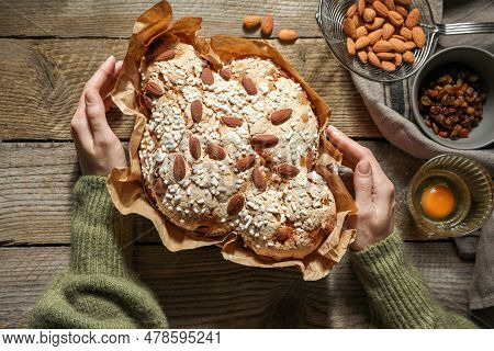 Woman With Delicious Italian Easter Dove Cake (traditional Colomba Di Pasqua) At Wooden Table, Top V