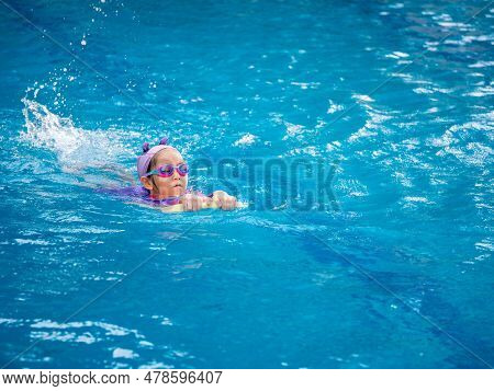 Asian Child Or Kid Girl Wearing Swimming Suit To Learning On Swimming Pool , Learn And Training Swim