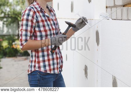 Insulation Of The House With Polyfoam. The Worker Is Checking With The Construction Level The Accura
