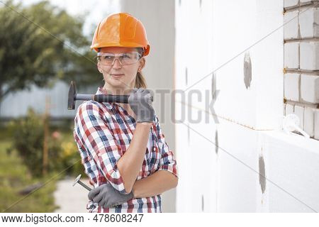 Insulation Of The House With Polyfoam. The Worker Is Checking With The Construction Level The Accura