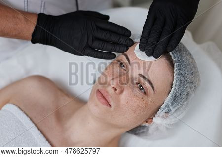 Beautician Cleanses Skin Of Woman With Cotton Sponge. .
