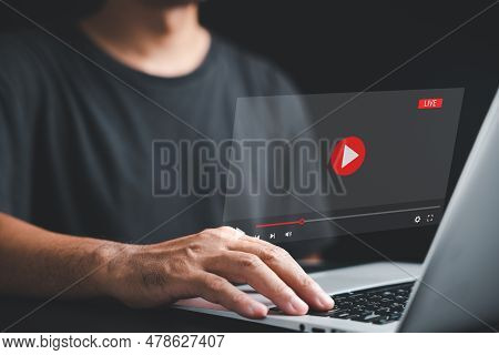 Businessman Immersed In A Live Stream On His Laptop. Online Video Streaming Concept With A Multimedi