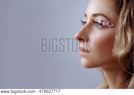 Profile Of A Beautiful Woman, With Creative Spring Floral Makeup And Perfect Glowing Skin. Isolated 