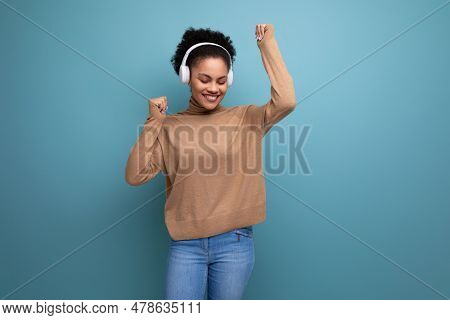Young Music Lover Woman With Swarthy Skin And Fluffy Hair Over Isolated Background With Copy Space