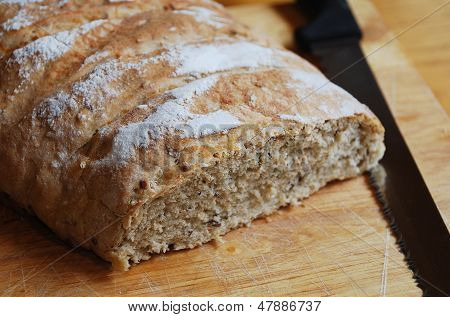 Sourdough On Chopping Board With Knife