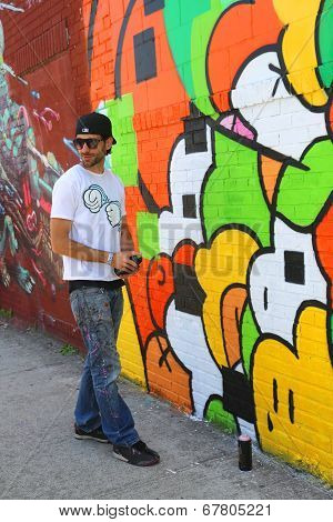 Street artist painting mural at Williamsburg in Brooklyn