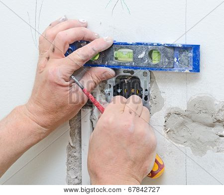 Certified Electrician Installing Socket For Light Switch.