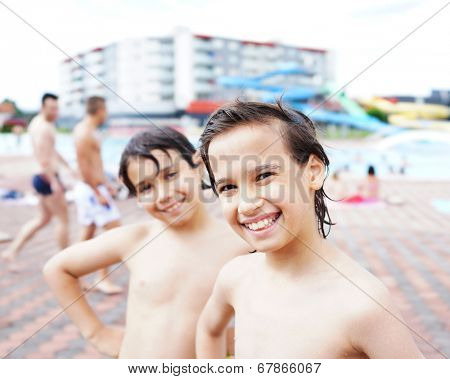 Happy little boys enjoying relaxing and splashing in water