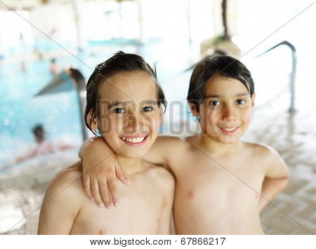 Happy little boys enjoying relaxing and splashing in water