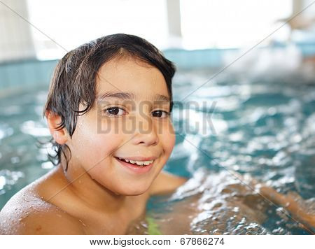 Happy little boys enjoying relaxing and splashing in water