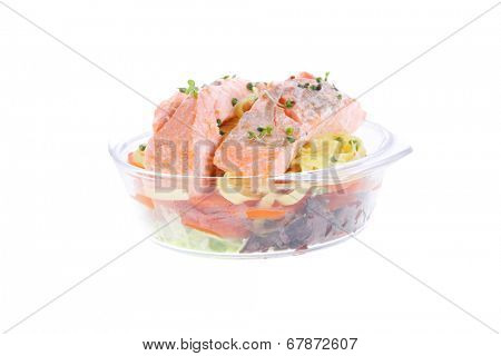 fresh fried natural pink salmon on italian traditional tagliatelle backed with tomato and vegetables isolated over white background