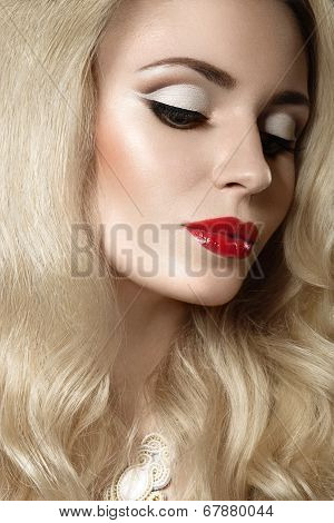 Beautiful blonde woman with evening make-up and red lips