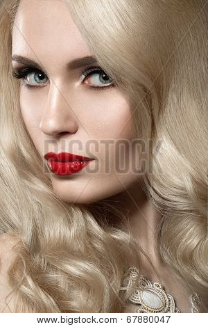 Beautiful blonde woman with evening make-up and red lips