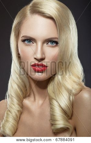 Beautiful blonde woman with evening make-up and red lips