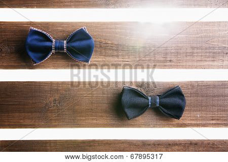 Set of handmade bow tie over wooden background
