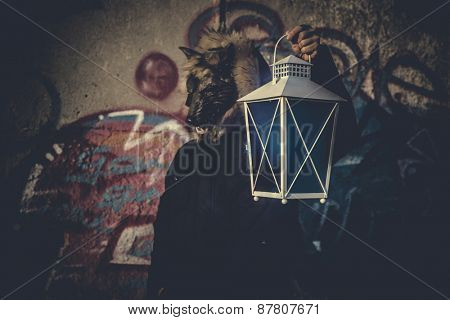man with mask wolf and lamp with colored smoke