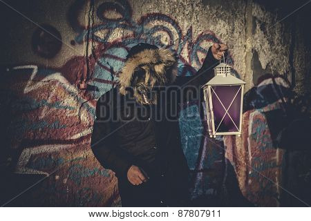 man with mask wolf and lamp with colored smoke