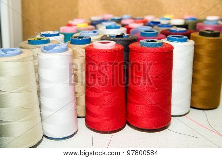Many Reels Of  Threads Standing On The Table