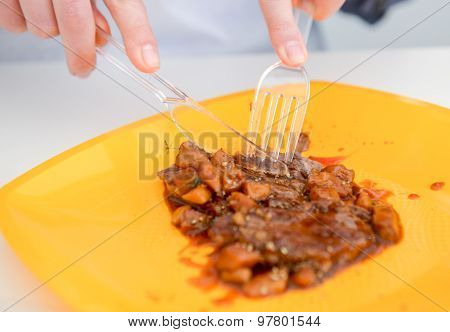 dish of pork with sauce on the yelloow plate