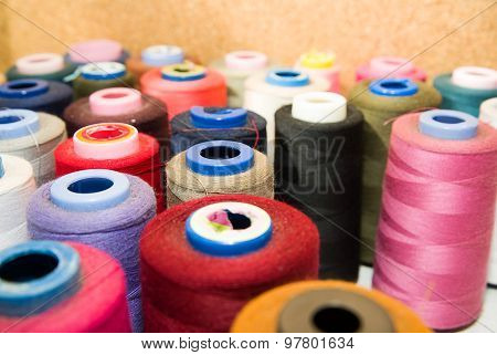 Many Reels Of  Threads Standing On The Table