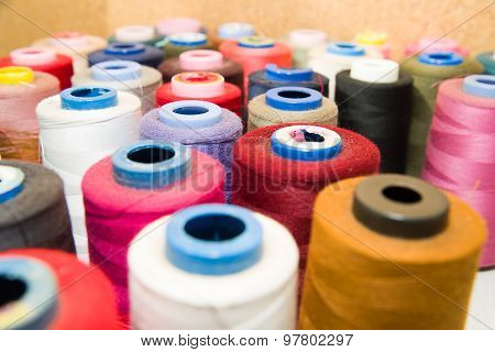 Many Reels Of  Threads Standing On The Table