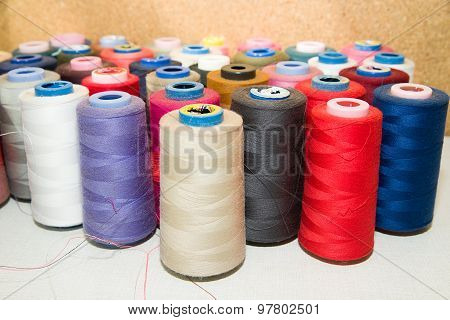 Many Reels Of  Threads Standing On The Table