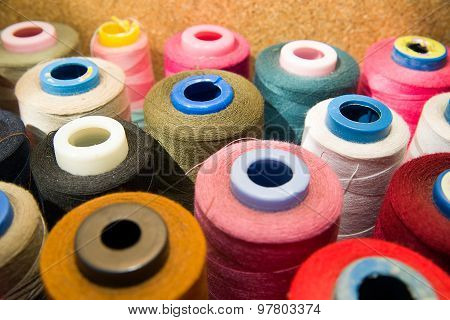 Many Reels Of  Threads Standing On The Table