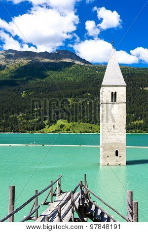 tower of sunken church in Resia lake, South Tyrol, Italy