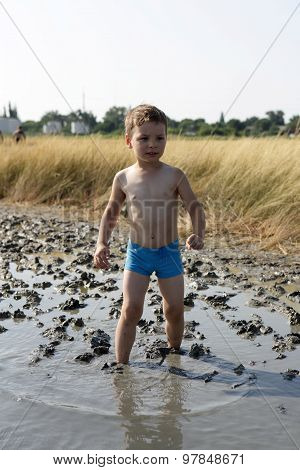 Boy Standing In The Healing Mud