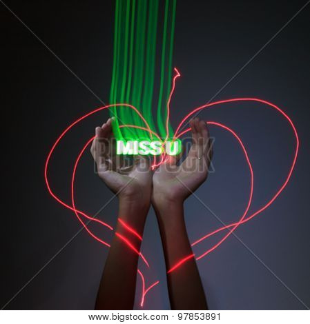 Light Painting Photography. Freezelight Photo. Hands Holding A Glowing Message With Freezelight Effe