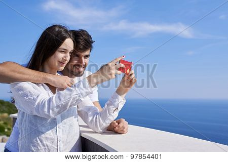 happy young couple taking selfie with cell phone