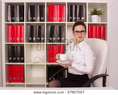 Business woman sitting with cup of coffee