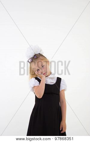 Schoolgirl with glasses standing worried