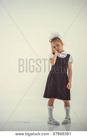 Schoolgirl with glasses standing worried