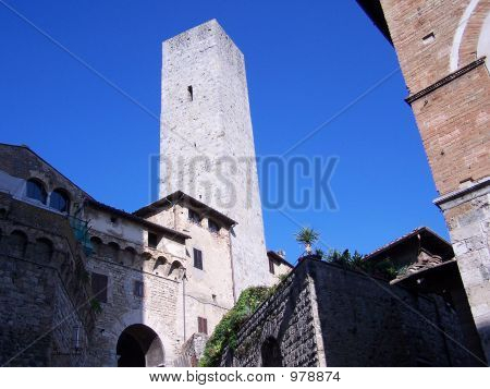 Tower In Historic Tuscan Town Against Blue Sky