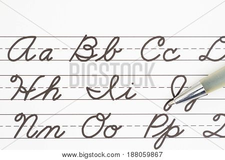 Learning to write cursive lettering Samples of cursive lettering on lined paper with a pen