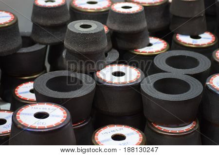 grindstones for grinding and sharpening, neatly lined up on each other