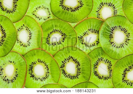 Kiwi cut by segments. The green fruit background.