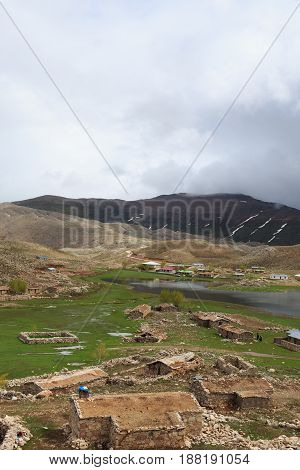 Mountain Landscape With Sloped Covered By Melting Snow And Villa