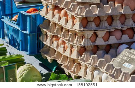 RHEYDT, GERMANY - OCTOBER 08, 2016: Fresh eggs and vegetables are piled up on a booth of a local market