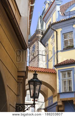 Narrow street with lantern view on tower of Old Town Hall Prague Czech Republic Europe