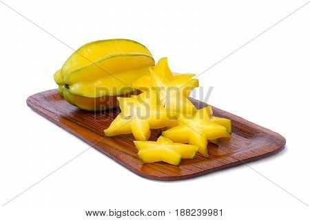 Star fruit and slice of star fruit on the wooden rounded rectangle tray isolate on white background