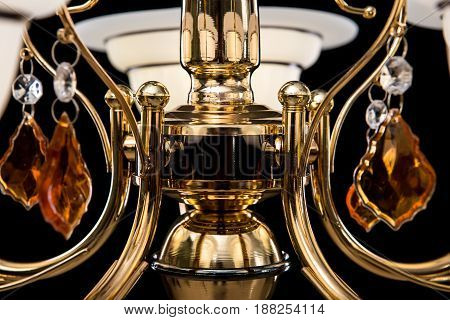 Classic Chandelier for interior decoration of the living room. Chandelier close-up photo isolated on black background. Gold modern a piece of interior for designers.